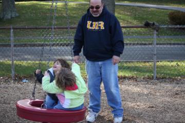 Ian pushes the kids on the tire