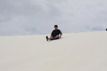 Robert sledding at White Sands