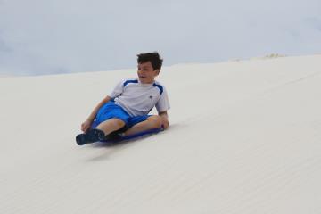Jonathan sledding at White Sands